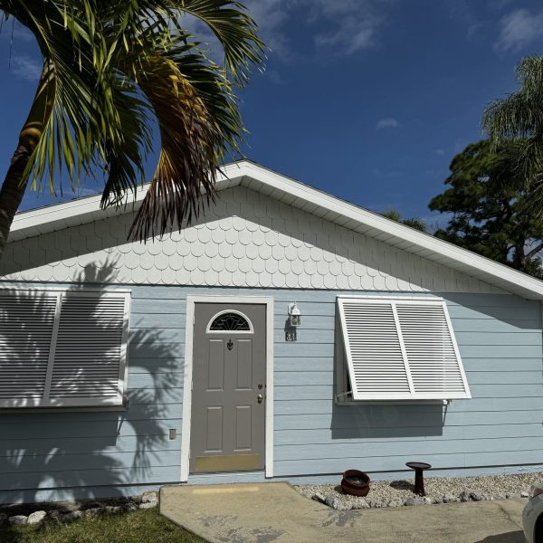 Exterior of a home near Siesta Key painted with Sherwin-Williams Snowball using Emerald paint, providing a bright, durable finish by Gulf Coast Painting SRQ.