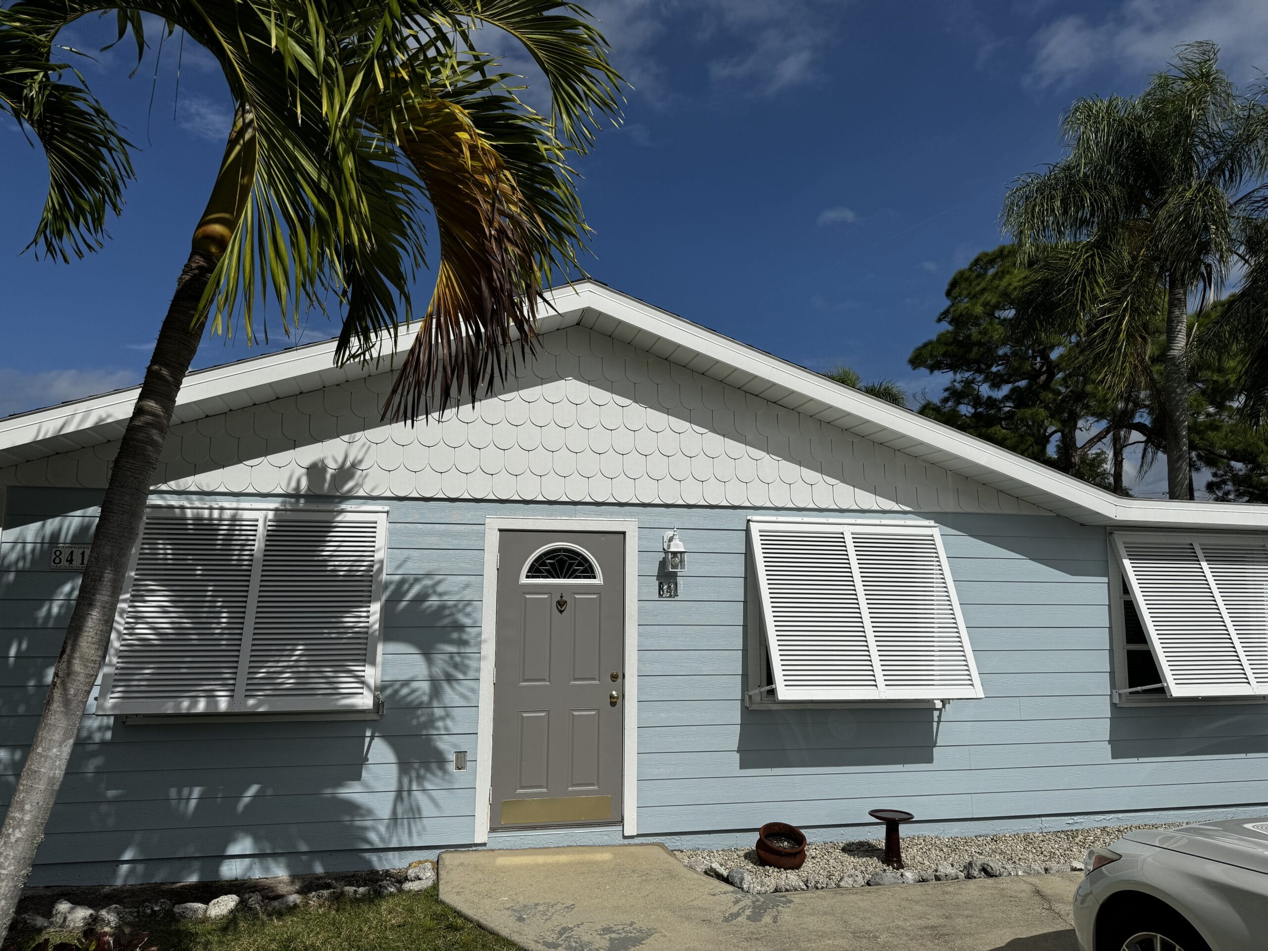 Exterior of a home near Siesta Key painted with Sherwin-Williams Snowball using Emerald paint, providing a bright, durable finish by Gulf Coast Painting SRQ.