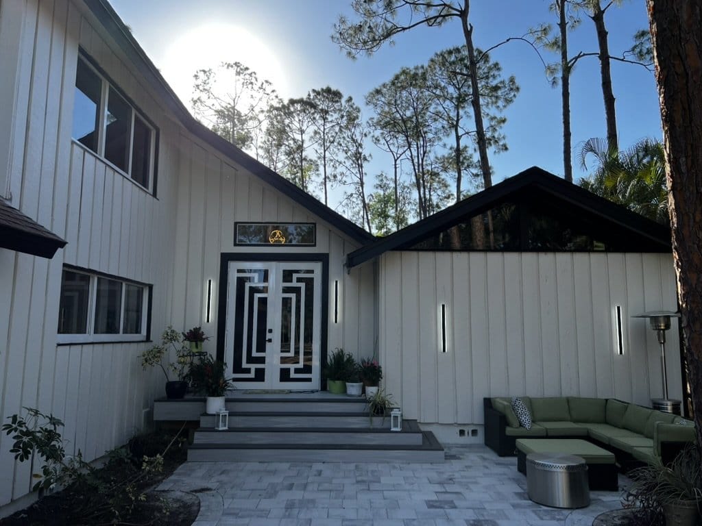 Before and after exterior painting transformation by Gulf Coast Painting SRQ – showcasing a home with fresh white paint and updated front entrance in Sarasota.