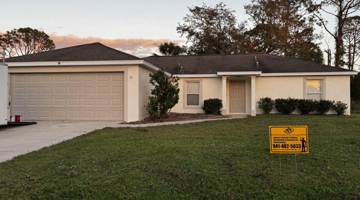 Freshly painted exterior of a coastal-style home in Venice, Florida, featuring a crisp white finish with gray trim, showcasing professional painting craftsmanship.