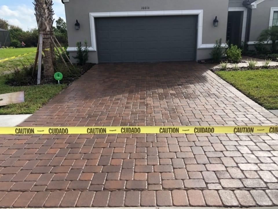Concrete driveway being professionally pressure washed