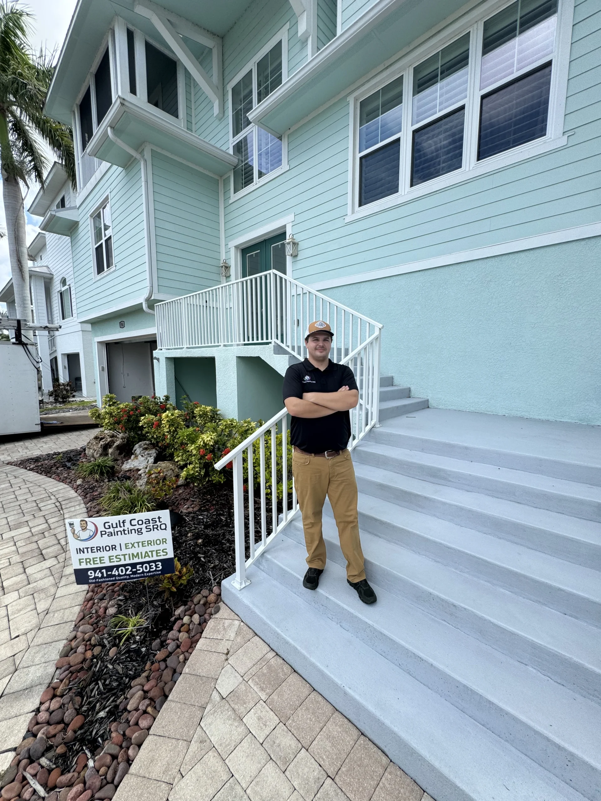 Chase, owner of Gulf Coast Painting SRQ, outside a completed Sarasota painting project